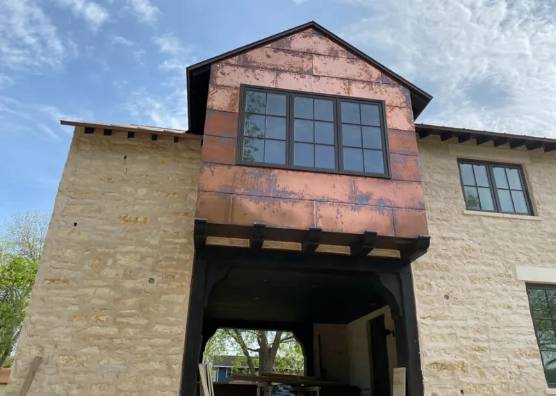 Copper metal panel facade on a stone building for Roof Repair in Iowa Park