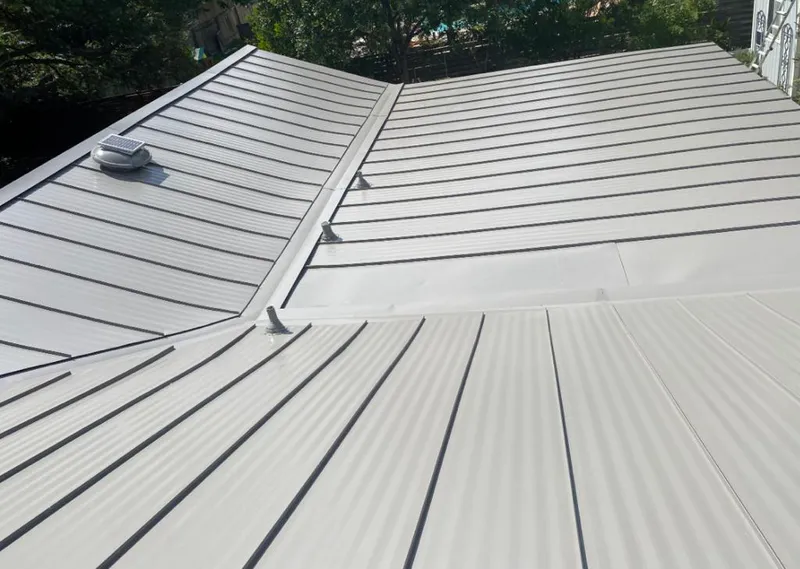 Solar attic fan installed on a metal roof for Roof Ventilation in Iowa Park